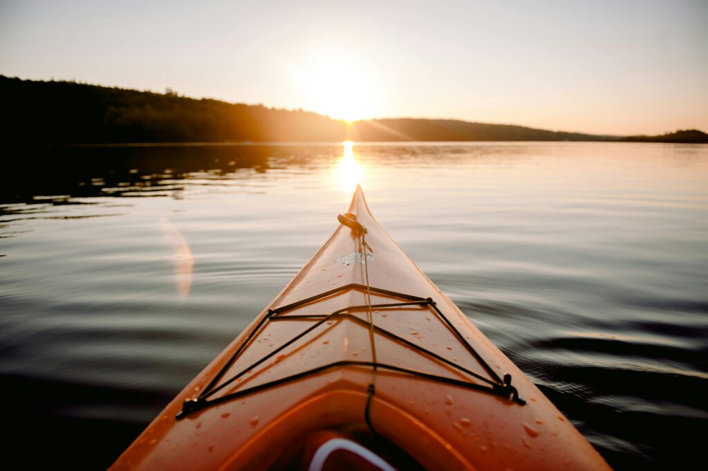 Front of a kayak on a lake